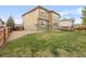 Green backyard with grass, a deck with dining area, and privacy fence at 13664 Cherry St, Thornton, CO 80602