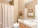 Cozy bathroom with neutral walls featuring a shower with curtain, and a large vanity with mirror at 13664 Cherry St, Thornton, CO 80602