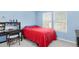 Blue bedroom with desk area and window at 13664 Cherry St, Thornton, CO 80602