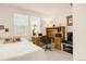 Bright bedroom featuring a wooden desk, a comfortable bed, and natural light from two windows at 13664 Cherry St, Thornton, CO 80602