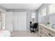 Well-lit bedroom with light gray walls, white trim, closet and windows, plus a desk at 13664 Cherry St, Thornton, CO 80602