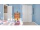 Bright blue bedroom with a double closet and sports-themed bedspread at 13664 Cherry St, Thornton, CO 80602