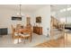 Spacious dining area with hardwood table, chairs, chandelier, and view to the stairs at 13664 Cherry St, Thornton, CO 80602