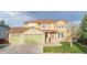 Charming two-story home with a three-car garage, well-maintained lawn, and stone accents at 13664 Cherry St, Thornton, CO 80602
