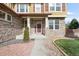 Inviting front entrance with stone accents, manicured landscaping, and a covered porch provides curb appeal at 13664 Cherry St, Thornton, CO 80602