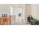 Carpeted hallway featuring a console table and an open doorway into an office space at 13664 Cherry St, Thornton, CO 80602