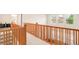 Hallway with wood railing and carpeted floor at 13664 Cherry St, Thornton, CO 80602