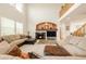 Stunning living room featuring a cozy fireplace, high ceilings, and natural light at 13664 Cherry St, Thornton, CO 80602