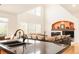 Open-concept living room showcases a cozy fireplace and large windows at 13664 Cherry St, Thornton, CO 80602