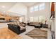 Spacious living room open to the kitchen boasts large windows and comfortable seating at 13664 Cherry St, Thornton, CO 80602