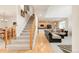 Open living space with hardwood floors connecting the kitchen and living area at 13664 Cherry St, Thornton, CO 80602