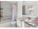 Bathroom featuring a shower-tub combo, white vanity and a granite countertop at 2027 Terry St # 1, Longmont, CO 80501