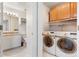 Bathroom and laundry area featuring a modern washer/dryer and stylish vanity at 2027 Terry St # 1, Longmont, CO 80501