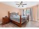 Comfortable bedroom with a decorative iron bed frame, wood flooring, and bright window with nice curtains at 2027 Terry St # 1, Longmont, CO 80501