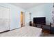 Bedroom features wood floors, double door closet, and a TV at 2027 Terry St # 1, Longmont, CO 80501