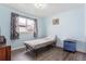 Bedroom featuring wood floors and large window at 2027 Terry St # 1, Longmont, CO 80501