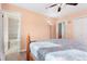 Comfortable bedroom with a decorative iron bed frame, wood flooring, and an open door to the bathroom at 2027 Terry St # 1, Longmont, CO 80501