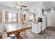 Inviting dining area featuring wood floors, bright windows, and an open layout flowing into the kitchen at 2027 Terry St # 1, Longmont, CO 80501