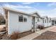 Charming single-story home featuring light gray siding, a welcoming entrance, and well-maintained landscaping at 2027 Terry St # 1, Longmont, CO 80501