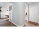 Bright hallway with clean white walls, wood floors, and views into the kitchen and entryway at 2027 Terry St # 1, Longmont, CO 80501