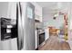 Bright kitchen with stainless steel appliances, white cabinetry, and wood floors at 2027 Terry St # 1, Longmont, CO 80501