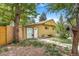 The exterior of the home with a well-maintained lawn, mature trees and landscaped yard at 525 Willow Dr, Brighton, CO 80603