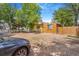 Spacious, sunny backyard featuring a cozy picnic area and partially fenced-in yard at 525 Willow Dr, Brighton, CO 80603