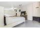 Bright bedroom with tile flooring, a ceiling fan, a large TV and an electric fireplace at 525 Willow Dr, Brighton, CO 80603