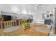 A spacious dining room featuring hardwood table and marble flooring, seamlessly connected to the living area at 525 Willow Dr, Brighton, CO 80603