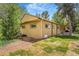 The exterior of the home with a well-maintained lawn, mature trees, and landscaping enhancing its curb appeal at 525 Willow Dr, Brighton, CO 80603