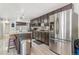 A modern kitchen featuring a large island with a marble countertop and plenty of cabinet storage at 525 Willow Dr, Brighton, CO 80603