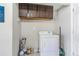 Functional laundry room featuring white washer and dryer, along with overhead storage cabinets for supplies at 525 Willow Dr, Brighton, CO 80603