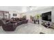 Inviting living room featuring comfortable leather seating, modern flooring, and a large entertainment center at 525 Willow Dr, Brighton, CO 80603