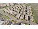 Aerial shot of a well-planned neighborhood with neatly arranged townhomes, landscaping, and community roads at 9792 Mayfair St # F, Englewood, CO 80112