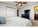 Spacious bedroom with a cozy bed, ceiling fan, ample closet space, and an en-suite bathroom for added convenience at 9792 Mayfair St # F, Englewood, CO 80112