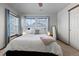 Comfortable bedroom with ample natural light, neutral decor and large windows with blinds at 9792 Mayfair St # F, Englewood, CO 80112