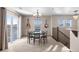 Inviting dining room with sliding glass doors and modern chandelier plus two guitars hanging on the wall at 9792 Mayfair St # F, Englewood, CO 80112