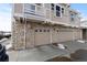 This home features a multi-car garage with stone accents. A sign restricts parking at 9792 Mayfair St # F, Englewood, CO 80112