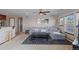 Open concept living room with carpet, sofa, ceiling fan, and large windows with lots of light at 9792 Mayfair St # F, Englewood, CO 80112