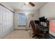 The home office includes a computer setup, a comfortable chair, neutral paint, a fan, and a closet at 9792 Mayfair St # F, Englewood, CO 80112
