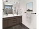 Modern bathroom with dual sinks, wood cabinets, sleek fixtures, and a large mirror at 2417 S Lafayette St, Denver, CO 80210