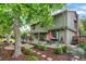 Serene backyard featuring a patio, lush garden, mature trees, and manicured landscaping at 7295 S Steele Cir, Centennial, CO 80122