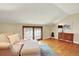 Bright bedroom featuring hardwood floors, complemented by a charming window seat and wooden trim at 7295 S Steele Cir, Centennial, CO 80122