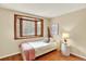 Bright bedroom features a bay window, hardwood floors, and neutral decor at 7295 S Steele Cir, Centennial, CO 80122