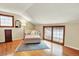 Bright bedroom featuring hardwood floors, complemented by a charming window seat and wooden trim at 7295 S Steele Cir, Centennial, CO 80122