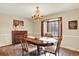 Elegant dining room with chandelier, window seat, and space for entertaining at 7295 S Steele Cir, Centennial, CO 80122