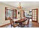 Traditional dining room with window bench, chandelier, and access to living area at 7295 S Steele Cir, Centennial, CO 80122