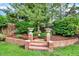 Picturesque garden with brick accents, landscaping, mature trees, and a tranquil water feature at 7295 S Steele Cir, Centennial, CO 80122