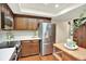 Kitchen with stainless steel refrigerator, ample cabinet space, and modern appliances at 7295 S Steele Cir, Centennial, CO 80122