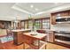 Open kitchen with stainless appliances, a kitchen island, and a view into the dining area at 7295 S Steele Cir, Centennial, CO 80122